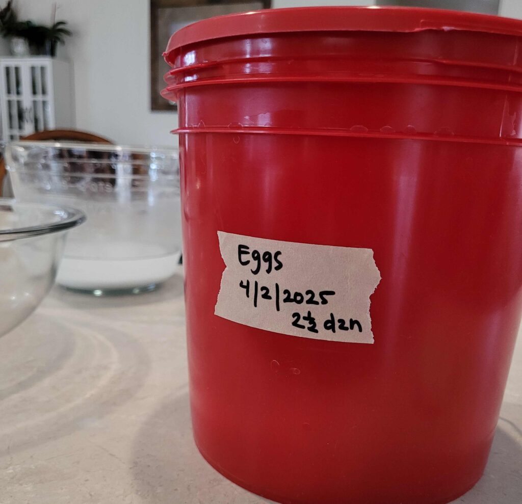 red lidded bucket with label on counter