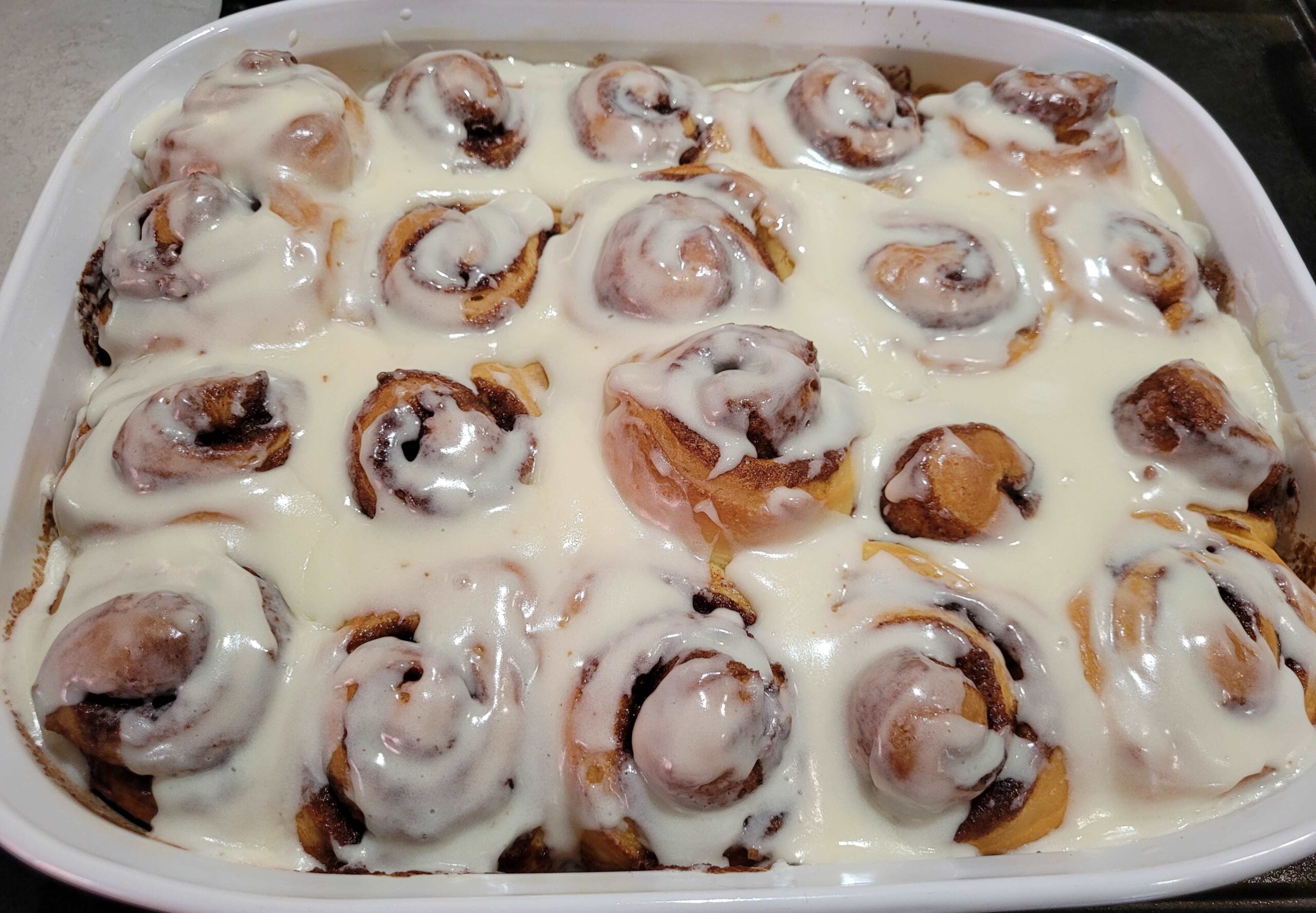 Pan of simple cinnamon rolls with white frosting