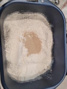 Flour and yeast in a bread machine pan