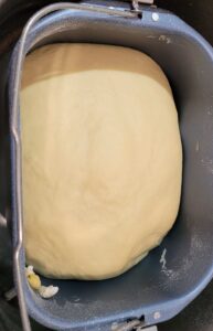 Cinnamon Roll dough ball in a bread machine pan