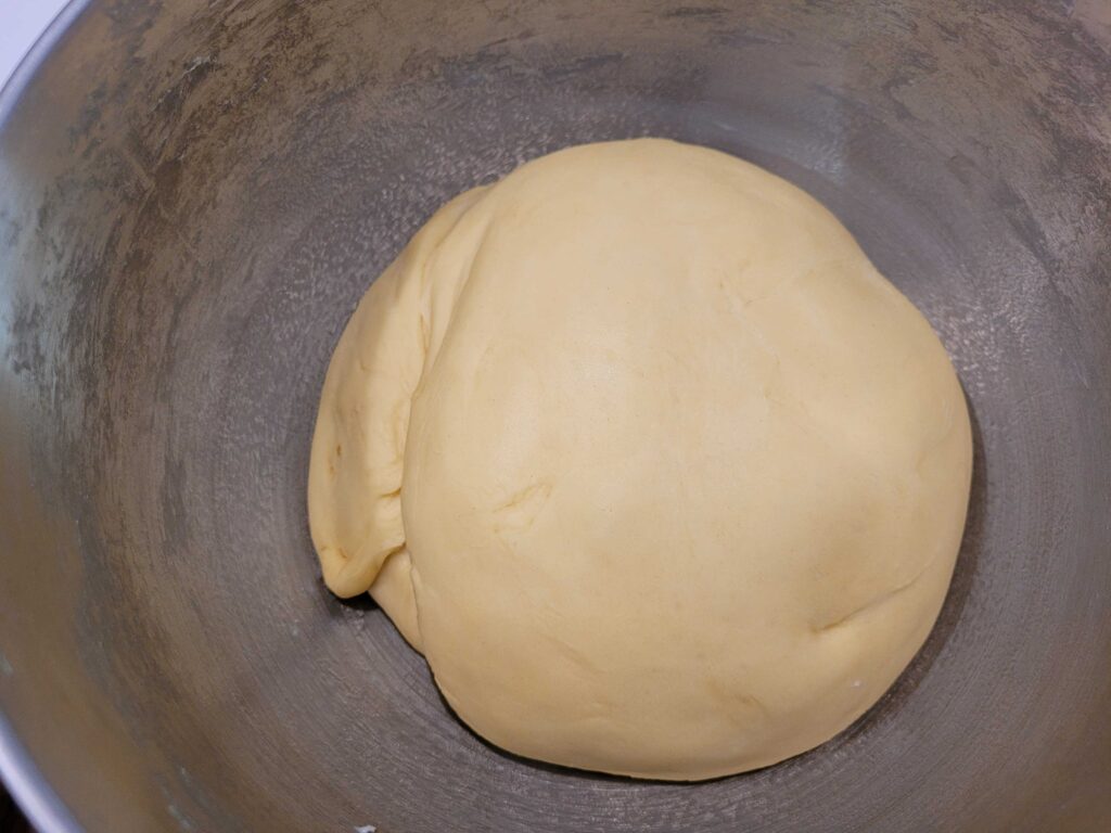 Cinnamon Roll dough ball in a mixer bowl after Rise 1